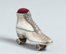 A CAST SILVER ROLLER SKATE PIN CUSHION.