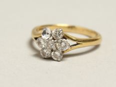 A 14CT GOLD AND DIAMOND CLUSTER RING