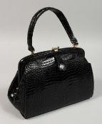 A BOB BLACK CROCODILE BAG. 9ins long.