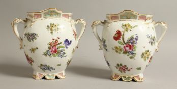 A PAIR OF MEISSEN DESIGN PORCELAIN TWO HANDLED VASES. 7ins high.