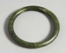 A GREEN JADE BANGLE.