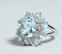 A SILVER AND BLUE STONE CLUSTER RING