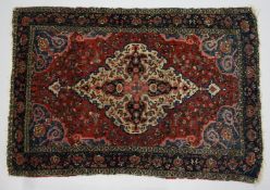 A PERSIAN BAKHTIARI CARPET, red ground with a beige ground, central lozenge shape panel. 6ft 3ins