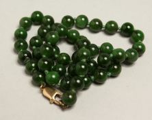 A JADE NECKLACE with gold clasp