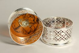 A PAIR OF SILVER PLATE AND FAUX TORTOISESHELL CIRCULAR WINE COASTERS.