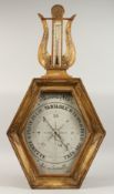 AN 18TH CENTURY TORICELLI TYPE BAROMETER, in a gilt wood frame, the octagonal dial, 6ins x 12ins,