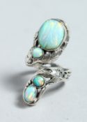 A SILVER AND NATURALISTIC OPAL SET RING.