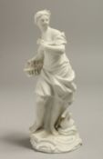 A LATE 18TH CENTURY / EARLY 19TH CENTURY MEISSEN BISCUIT FIGURE OF A GIRL with a basket, standing