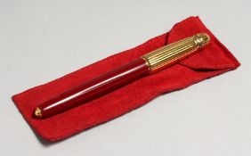 A GOOD CARTIER PASHADE, BURGUNDY AND RED FOUNTAIN PEN, with 18 carat gold nib, in a fitted case with