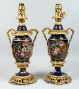A PAIR OF PARIS PORCELAIN AND ORMOLU MOUNTED URN SHAPED TABLE LAMPS, painted with panels of