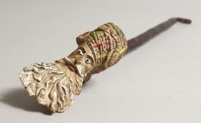 A FRENCH CLAY PIPE OF THE HEAD OF A TURK. 3ins, with wooden mouthpiece.