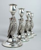 A GOOD SET OF FOUR OWL CANDLESTICKS on circular bases 7.5ins high.