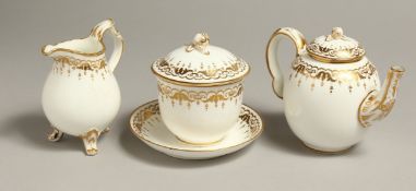 A COALPORT TETE-A-TETE TEA SERVICE with gilded decoration having a small teapot and cover with