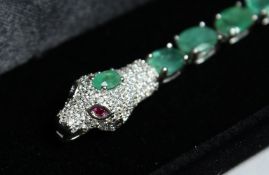 A SILVER EMERALD SNAKE LINE BRACELET.