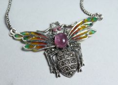 A SILVER RUBY MARCASITE AND PLIQUE ENAMEL BEE BROOCH.