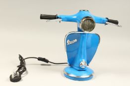 A BLUE VESPA LAMP.