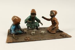 A VIENNA COLD PAINTED BRONZE GROUP, boys playing dice. 7.5ins x 5ins
