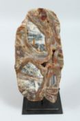 A SLICE OF AGATE on a stand 10ins x 5ins.