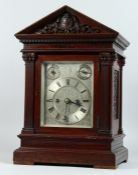 AN EDWARDIAN MAHOGANY MANTLE CLOCK, with eight day movement striking on a gong, engraved silvered