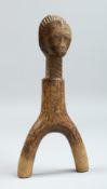 AN EARLY WOODEN FIGURE 7ins long.