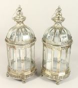 A PAIR OF METAL AND GLASS LANTERNS.