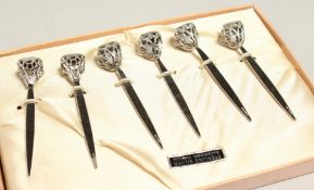 A SET OF SIX CORN ON THE COB SKEWERS