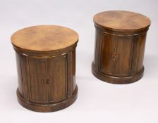 A PAIR OF MAHOGANY CIRCULAR PEDESTAL CUPBOARDS with single panel doors. 1ft 8ins diameter x 1ft 9ins