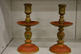 A pair of heavy patinated brass candlesticks.