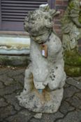 A composite garden fountain modelled as a cherub on a dolphin.