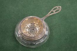 A Tiffany silver tea strainer and stand.