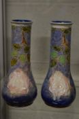A pair of Royal Doulton tubeline decorated vases.
