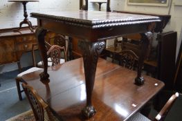 A mahogany draw leaf dining table on carved cabriole legs.