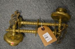 A pair of brass candle sconces.