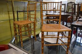 A pair of gilt wood faux bamboo occasional chairs.