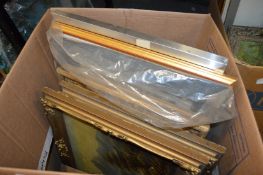 A box of paintings and prints.