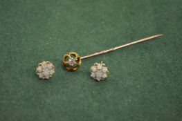 A tie pin and a pair of earrings.