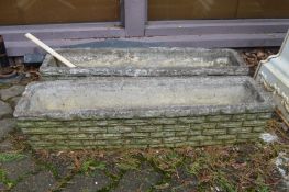 A pair of rectangular garden troughs.