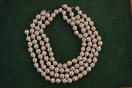 Various strands of pearl beads.