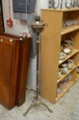 An adjustable floor standing oil lamp.