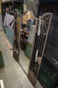 A folding wrought iron mirror.