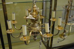 A good heavy cast brass eight branch chandelier with cherub mounts.