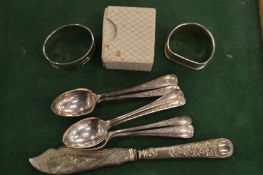 Silver napkin rings and other items.