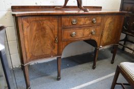A Georgian style mahogany serpentine fronted sideboard.