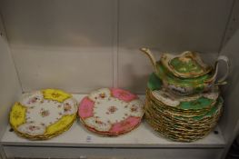 Decorative plates and a similar teapot.