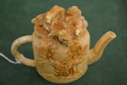 A carved bone teapot.