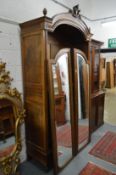 A good 19th century French walnut armoire with a pair of mirrored enclosing shelves.
