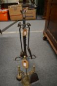 A wrought iron companion set and another set.