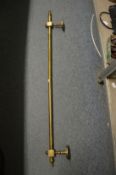 A Victorian brass curtain pole or chimney breast pole.