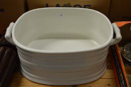 A large white glazed pottery twin handled foot bath.