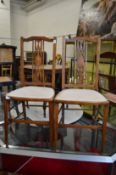 A pair of inlaid mahogany occasional chairs.